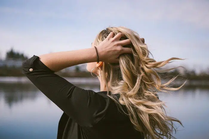 Woman holding hair from wind