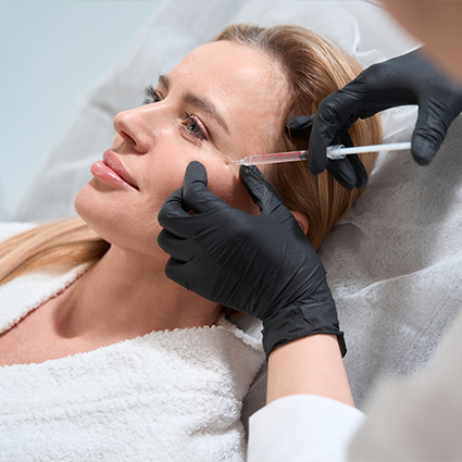 Woman Doing Facial Filler Treatment